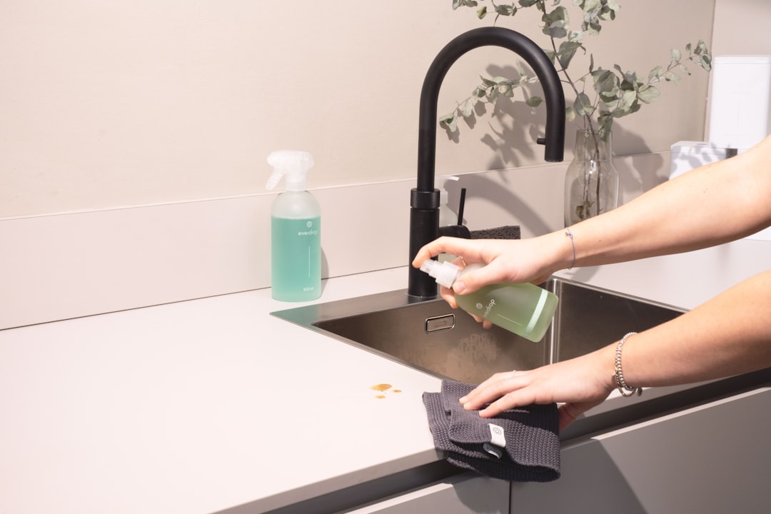 contact-img a-woman-is-cleaning-a-kitchen-sink-with-a-rag-sqomdoqb3ws